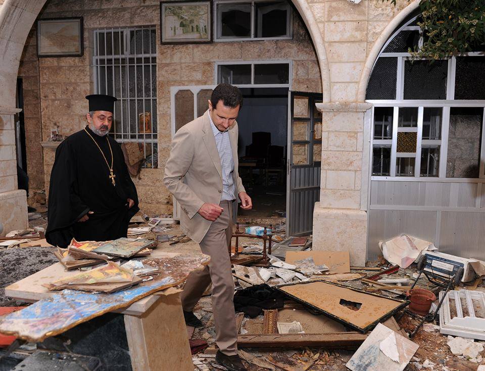 Præsidenten ser på skaderne fra terroristernes mange nedslag af vestlige mortér-granater over den lille gamle kristne by. 